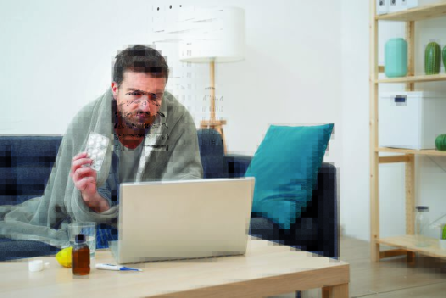 Sick,Man,Portrait,On,The,Sofa,Searching,Medicals,On,Internet