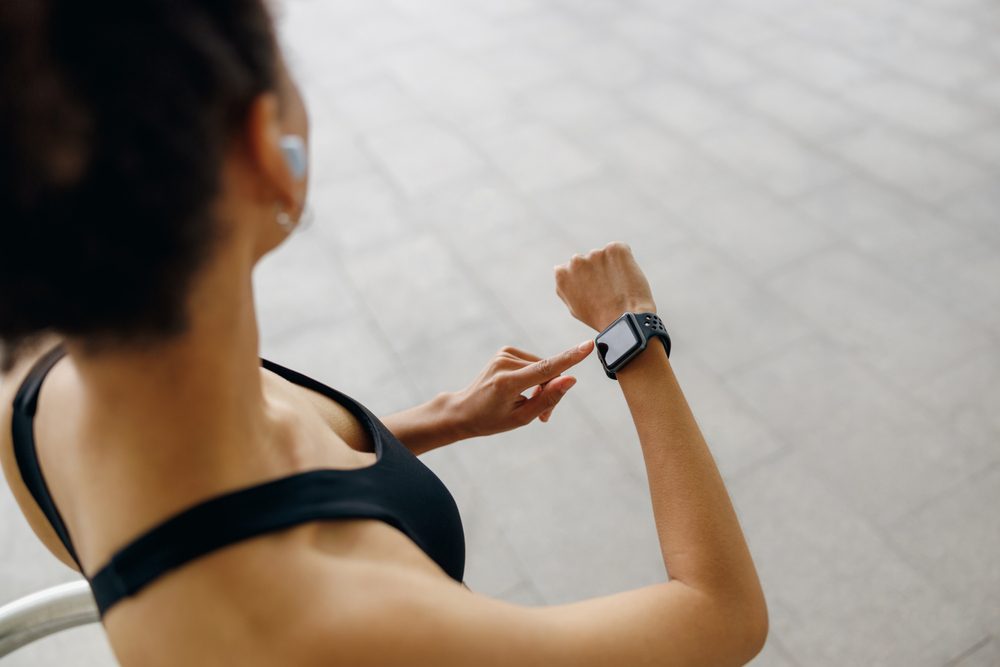 Close,Up,Of,Woman,In,Sportswear,Looking,On,Smartwatch,After