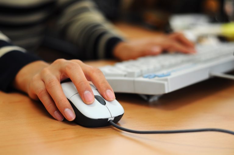 11234777man-with-sweater-at-computer-with-hand-on-mouse-768x510-11